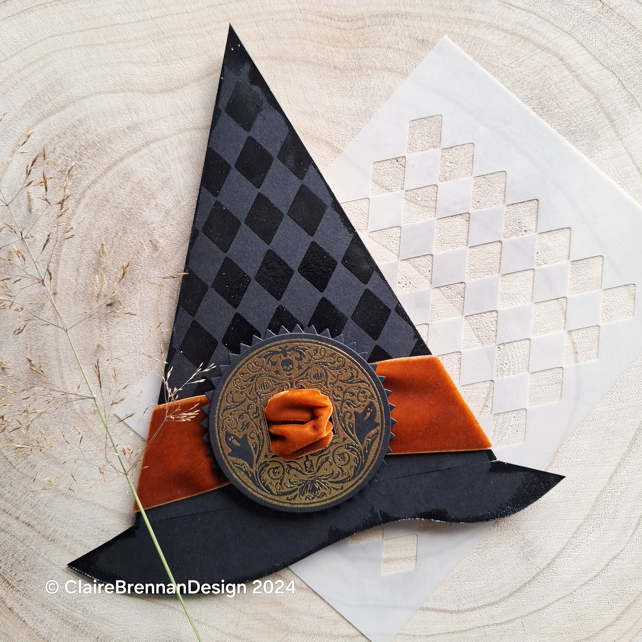 greetings card in the shape of a witches hat, with orange velvet bow and a buckle made from cardstock embossed with an ornate gold design