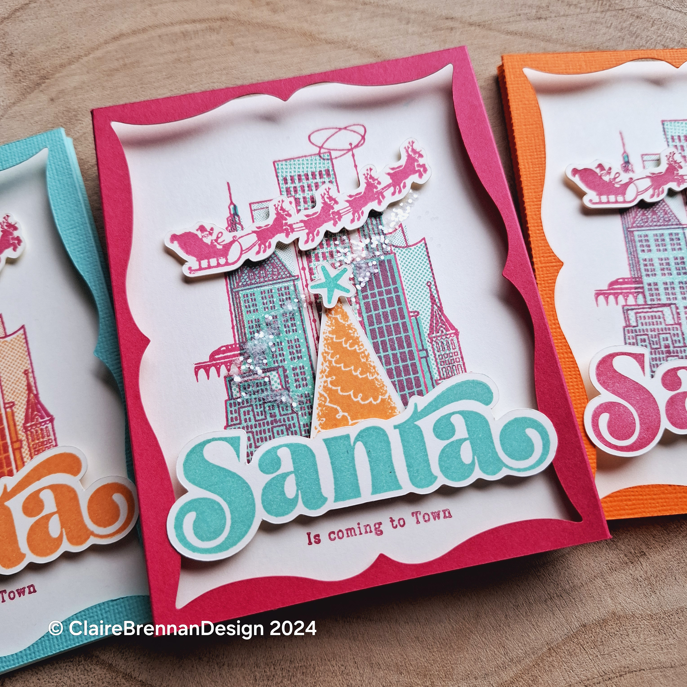 colourful greetings card featuring a retro style city scene with orange christmas tree and large blue word 'santa'