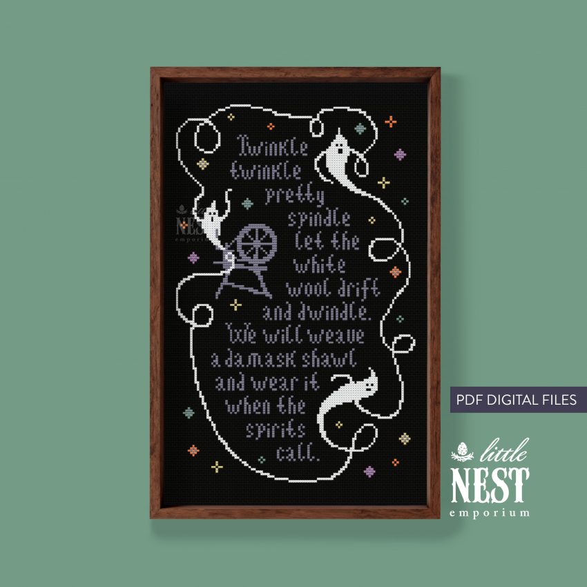A bron frame surrounds a piece of black cloth on which is cross stitched a poem and three white ghost shapes.