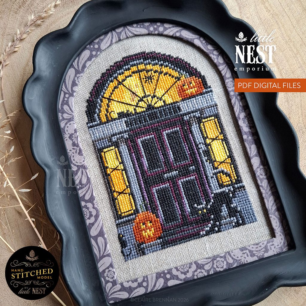 Cross stitch design on a Black Georgian Doorway, with a fanlight and side windows - in front of the door is a cat, two pumpkins and 3 rats, behind the door a ghost is partially seen